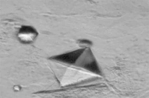 Figura 21. Cristal gigante (>35µm) de Oxalato cálcico dihidratado octaédrico con perfecta configuración bipiramidal tetragonal (400X, microscopia interferencial). Se asocia significativamente con hipercalciurias y litiasis. Fuente: Dalet, Fernando. El sedimento urinario: ¿qué hay de nuevo en algo tan viejo?. Act Fund Puigvert 1999;18(3):135-48.